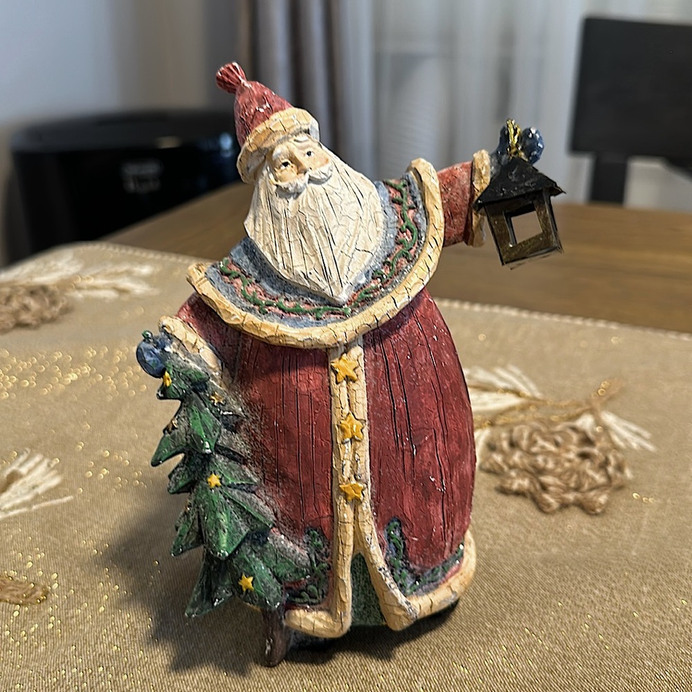 Beautiful Santa Claus figurine with a Christmas tree in the lamp